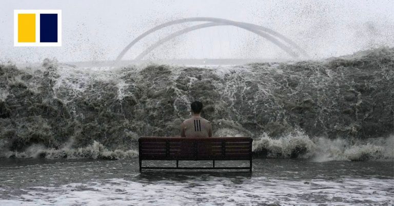 Photographer Tells Story Behind Powerful Image of Man Calmly Facing Super Typhoon