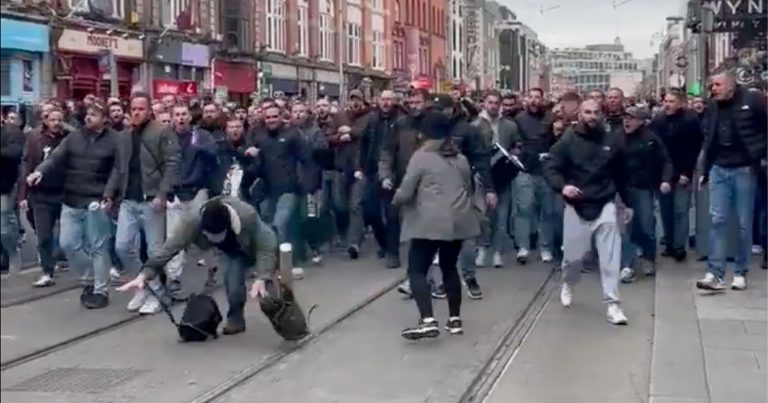 Soccer Hooligans Kick a Photographer in the Head and Spit on Another